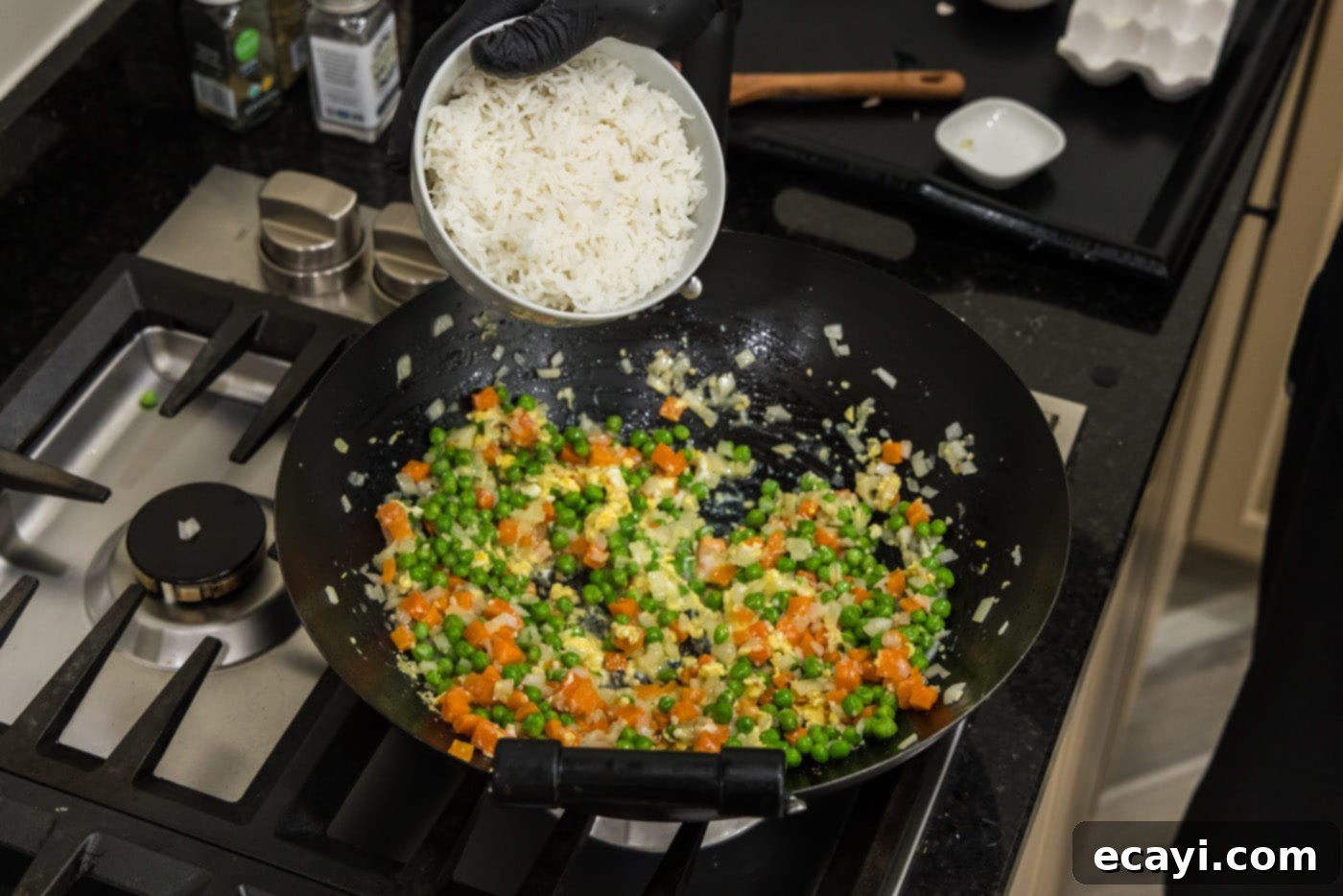 Golden Shrimp Fried Rice 12 adding cooked rice to wok with vegetables