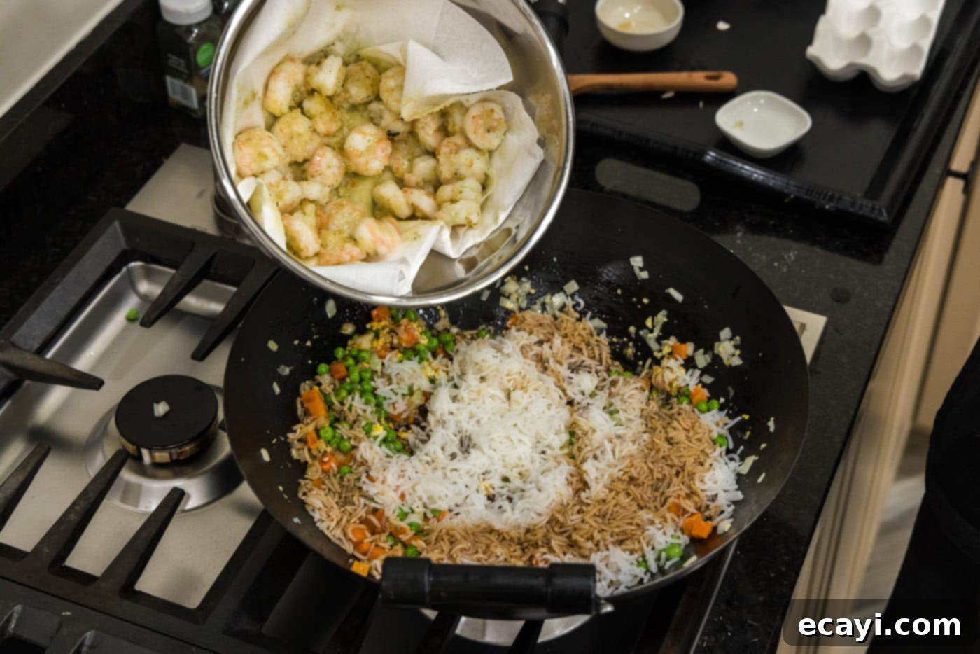 Golden Shrimp Fried Rice 14 adding cooked shrimp to wok with fried rice and vegetables