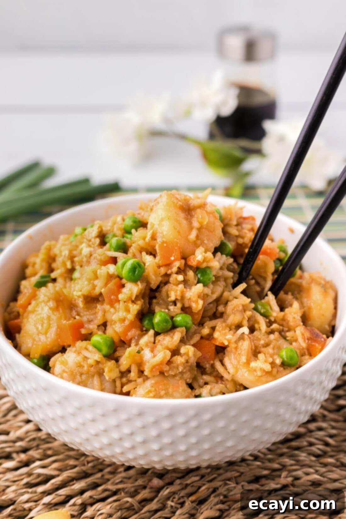 Golden Shrimp Fried Rice 16 Bowl of Shrimp Fried Rice with chopsticks in it