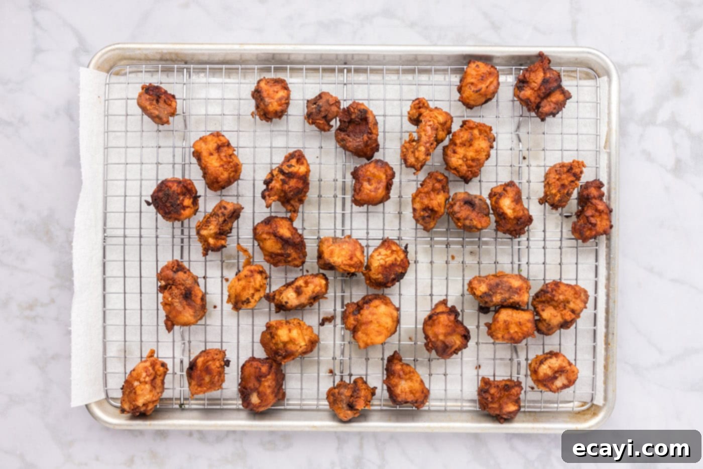 Tangy Glazed Pork Delight 13 crispy fried pork on a wire cooling rack