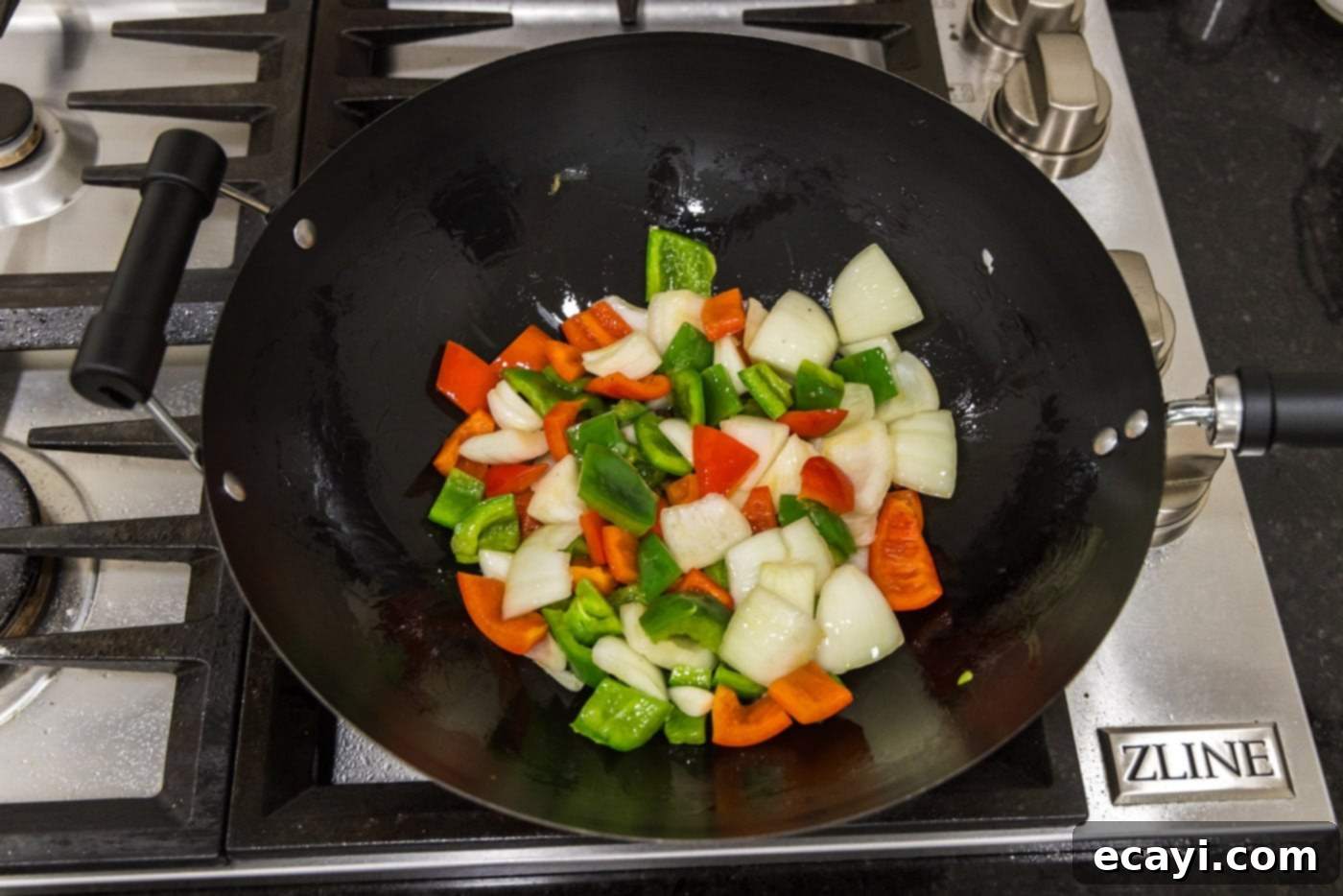 Tangy Glazed Pork Delight 14 onion and bell peppers in a wok