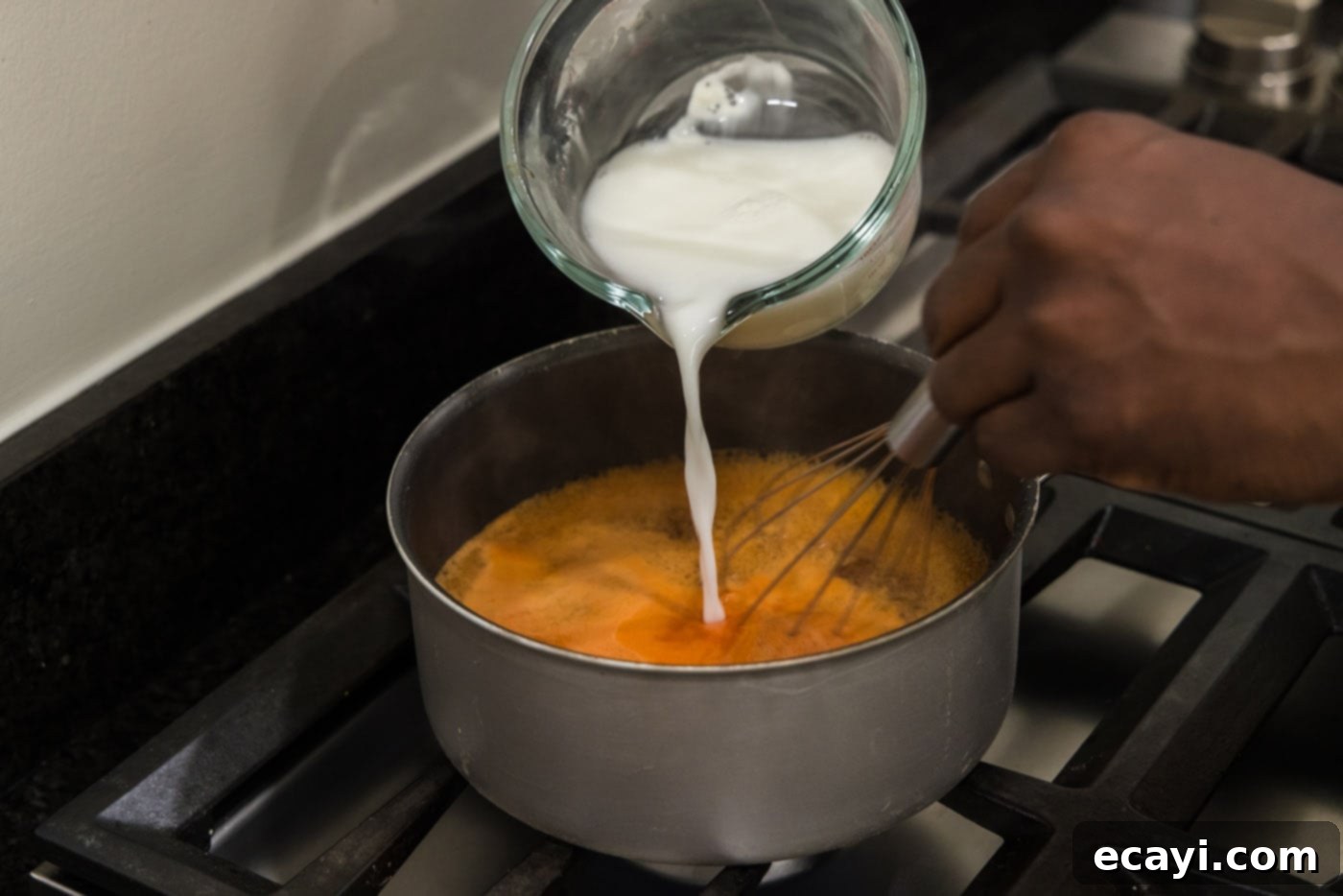 Tangy Glazed Pork Delight 7 pouring cornstarch slurry into sweet and sour sauce