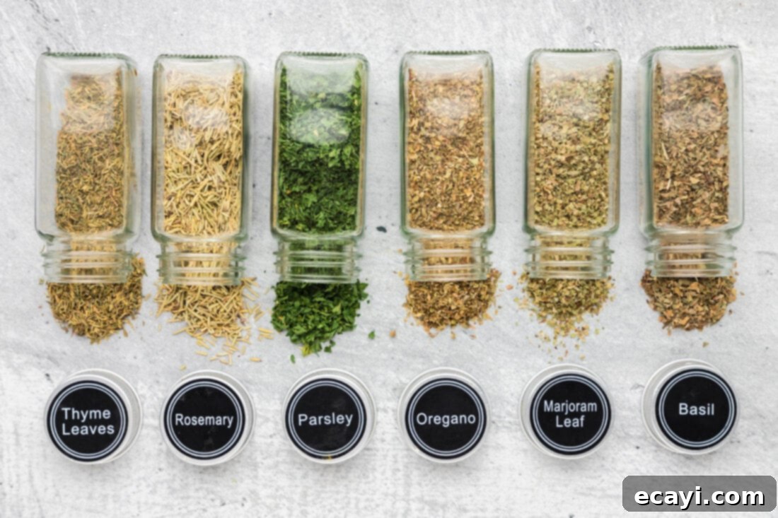 Classic Italian Herb Blend 4 Ingredients for Italian Seasoning laid out on a table, including dried oregano, basil, thyme, rosemary, marjoram, and parsley.