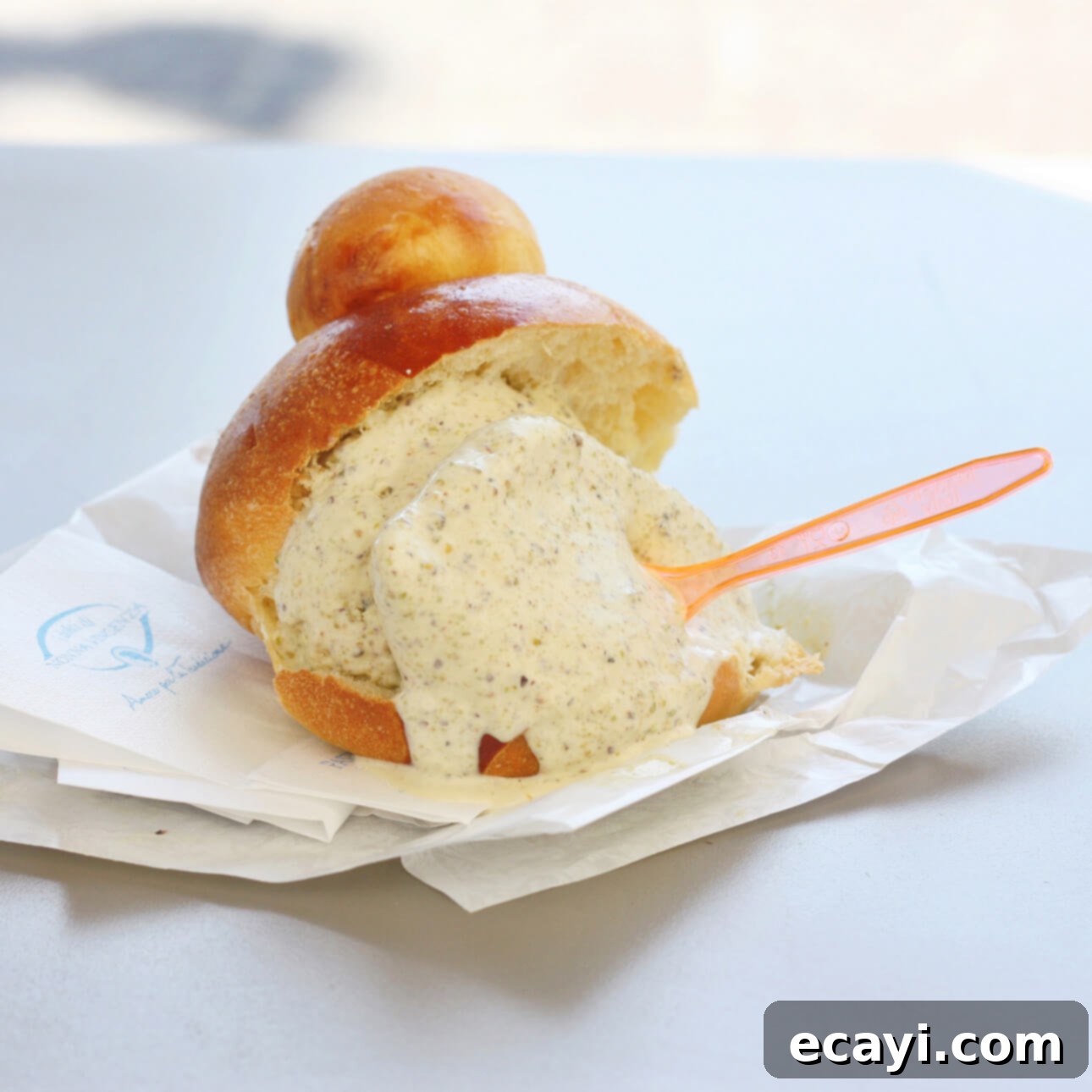 Authentic Pistachio Gelato from Our Homemade Paste 3 Sicilian gelato served in a brioche bun at I Dolci di Nonna Vicenza, in Catania, Sicily, showcasing authentic Italian dessert traditions. // FoodNouveau.com