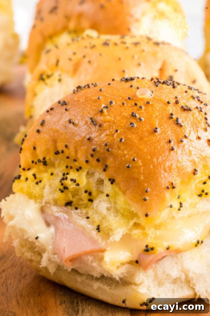 Easy Ham and Cheese Sliders: The perfect appetizer for football parties, potlucks, New Year's Eve, or any other reason to get together and celebrate! Classic Ham and Cheese Sliders with Hawaiian Rolls, perfect for parties and game day.