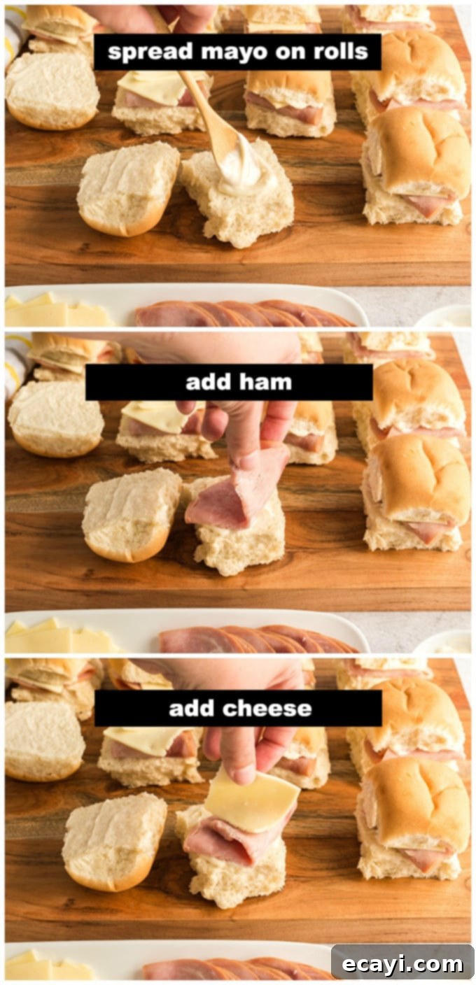 Ultimate Ham and Cheese Sliders 3 Assembling ham and cheese sliders, layering ham and cheese on Hawaiian rolls.