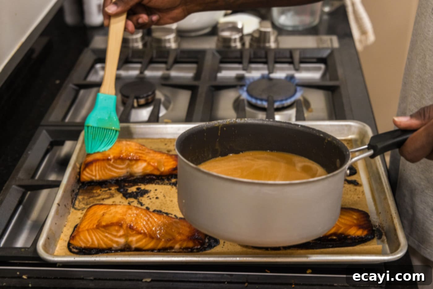 Miso Glazed Salmon 5 Close-up of baked miso salmon fillets being basted with a rich, caramelized miso glaze, showing the beautiful golden-brown finish