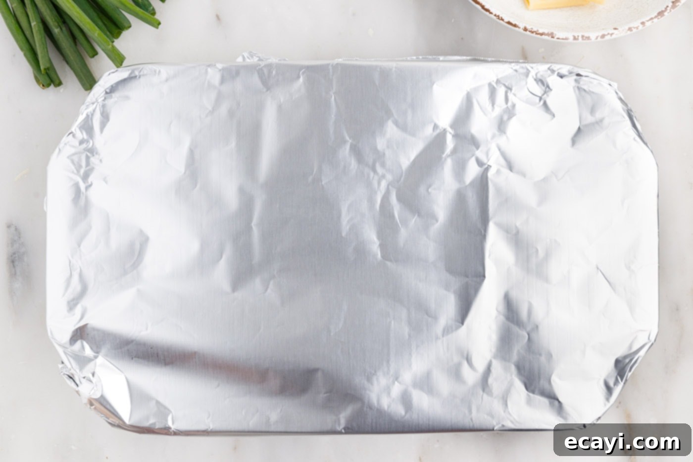 Fiery Chicken Comfort Bake 11 foil covering buffalo chicken casserole