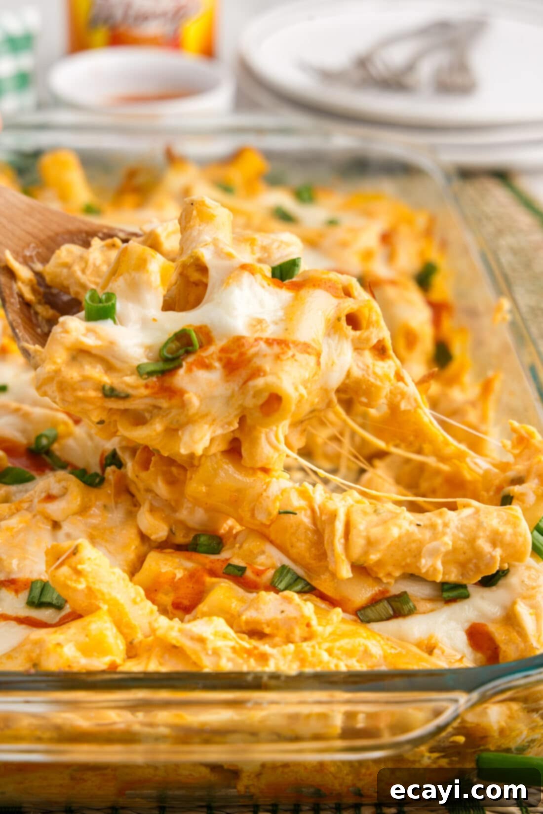 Fiery Chicken Comfort Bake 3 Spoonful of Buffalo Chicken Casserole being lifted out of the dish