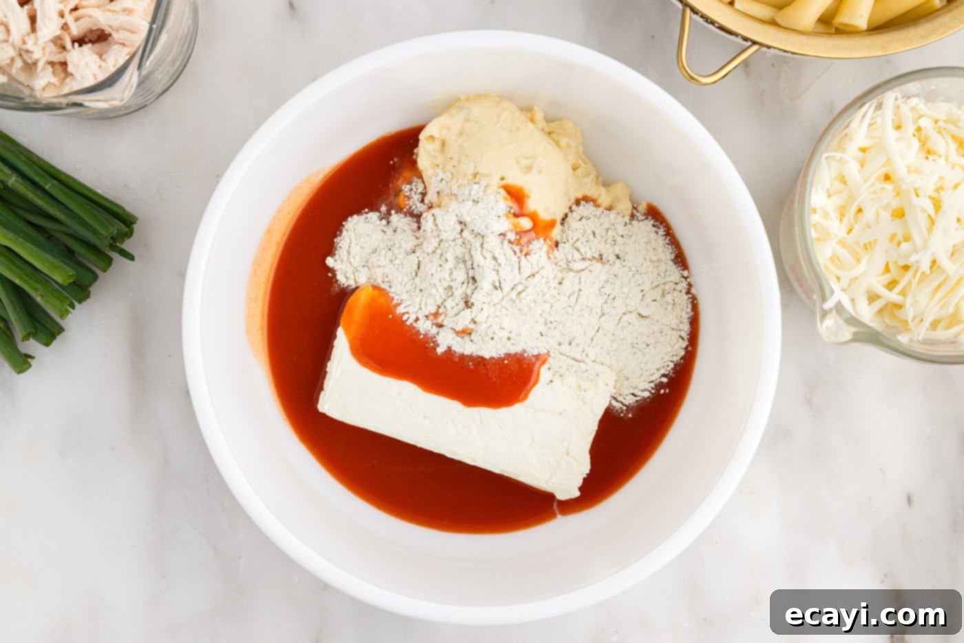 Fiery Chicken Comfort Bake 5 hot sauce, cream cheese, ranch seasoning mix, and cream f chicken soup in a bowl