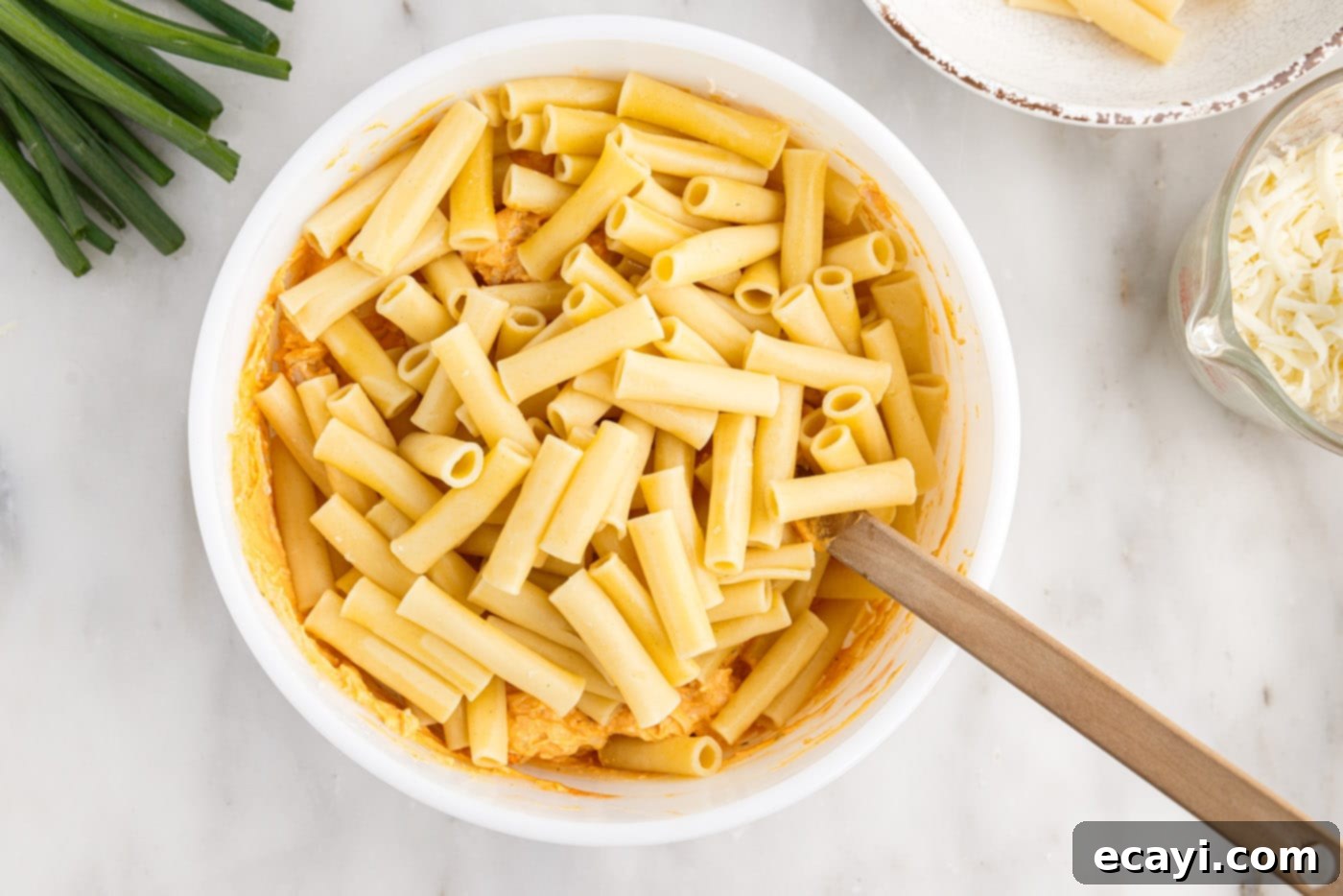 Fiery Chicken Comfort Bake 8 combining pasta with buffalo chicken mixture