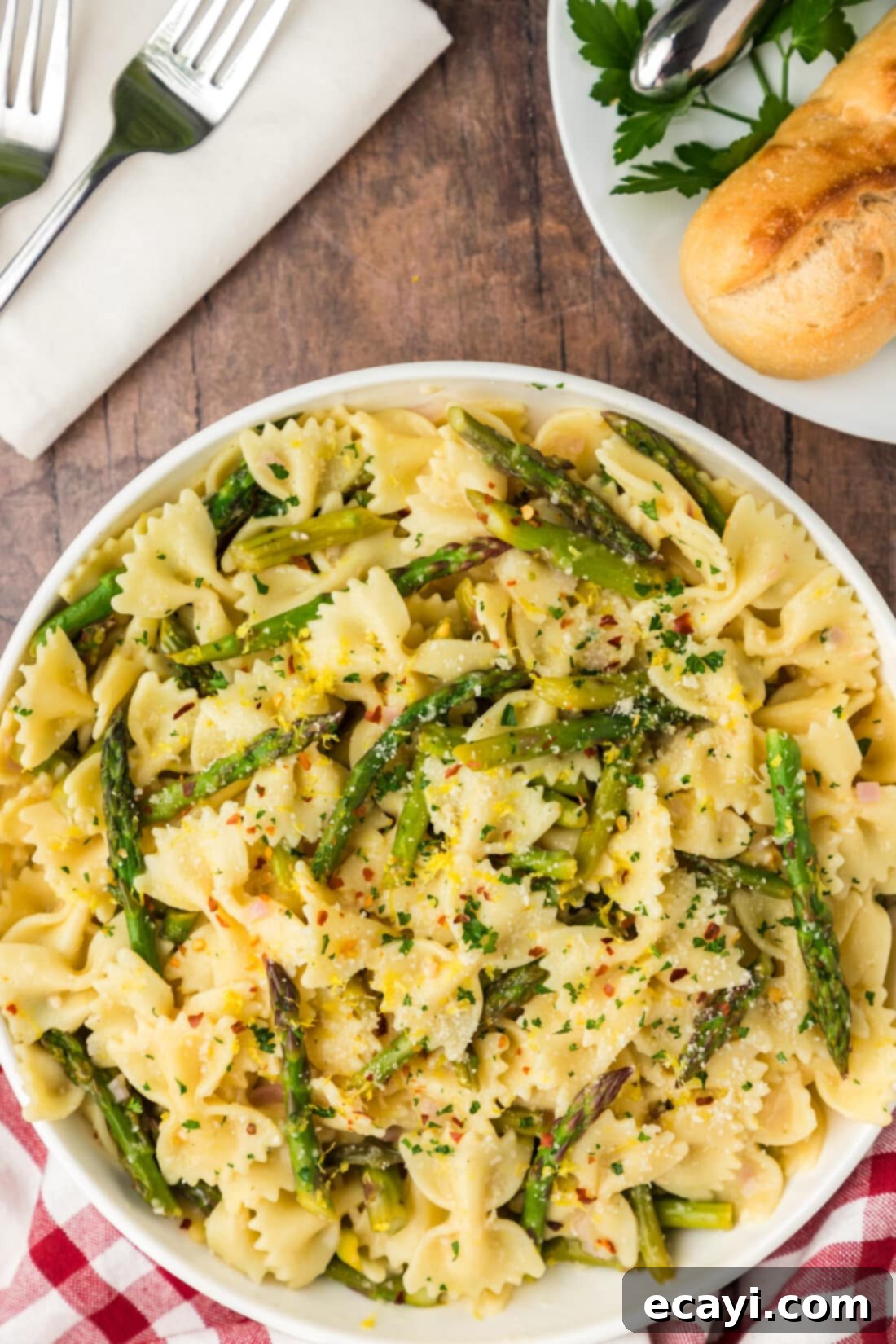 Bright Asparagus Pasta 2 Bowl of Asparagus Pasta with crusty bread on the side, highlighting the tender-crisp asparagus and creamy lemon garlic sauce over bowtie pasta.