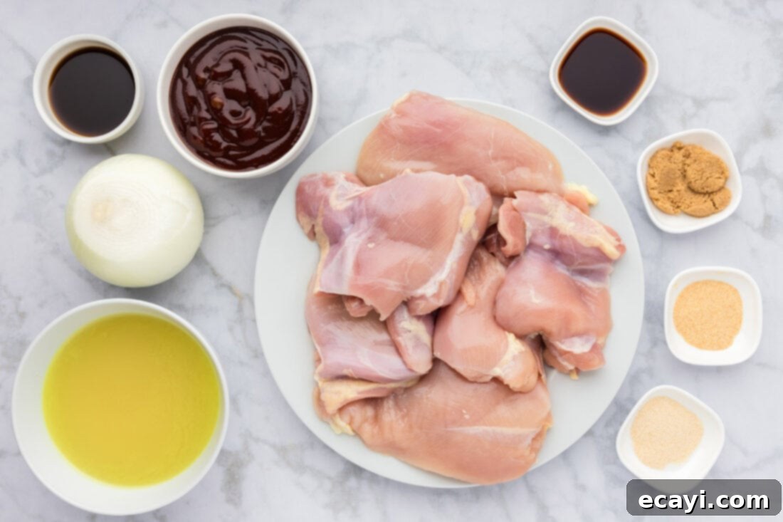 Tender Instant Pot BBQ Chicken 4 A selection of fresh ingredients laid out, including chicken breasts, chicken thighs, onions, barbecue sauce, and various spices for Instant Pot BBQ Chicken.