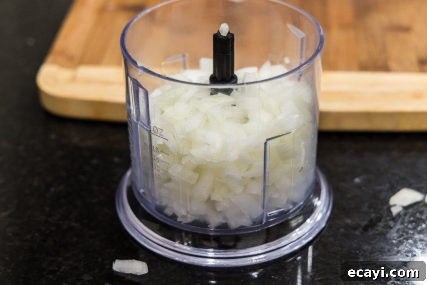 Tender Instant Pot BBQ Chicken 5 Coarsely chopped onion pieces in a food processor bowl before mincing.