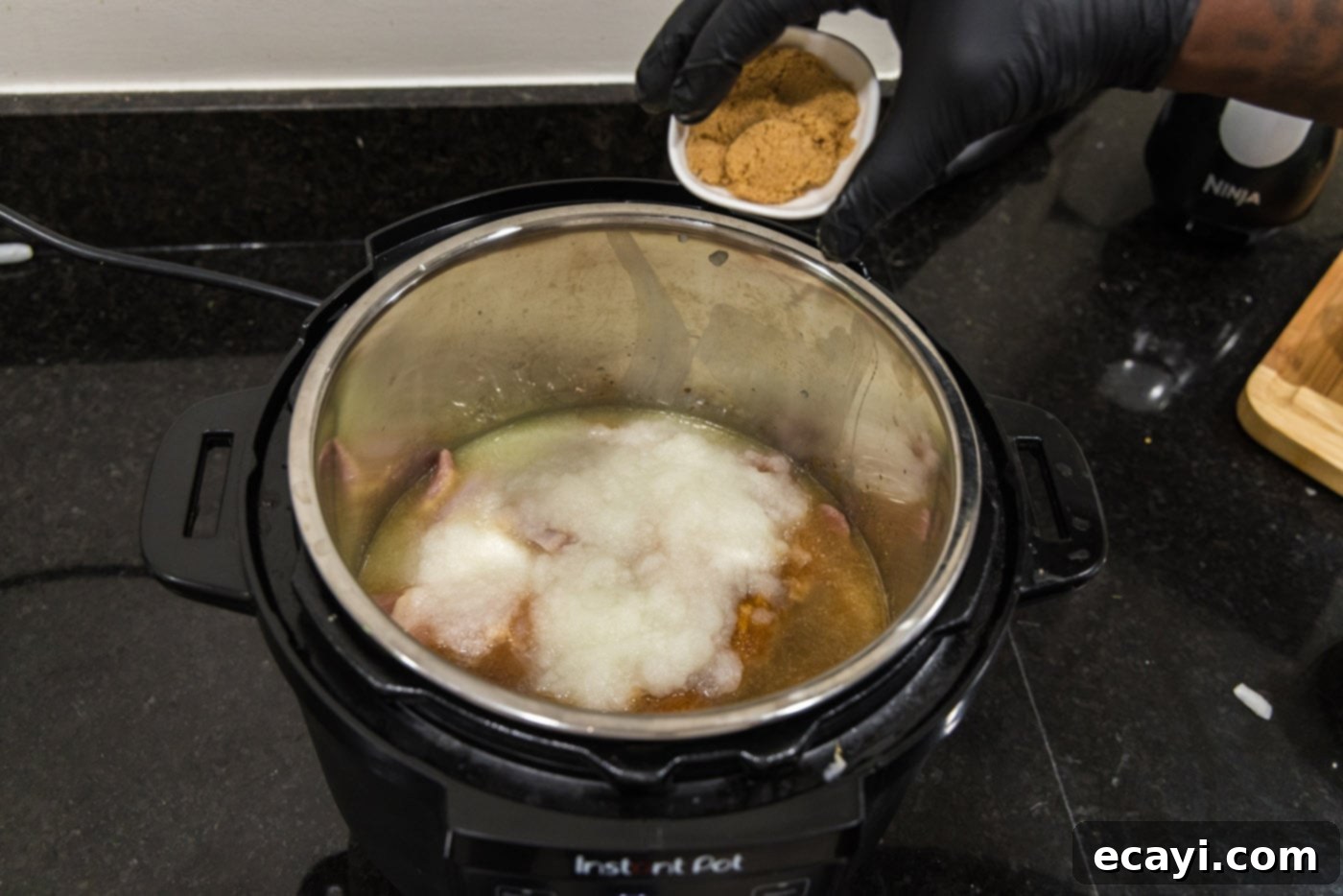 Tender Instant Pot BBQ Chicken 9 Adding brown sugar over the chicken and seasonings in the Instant Pot.