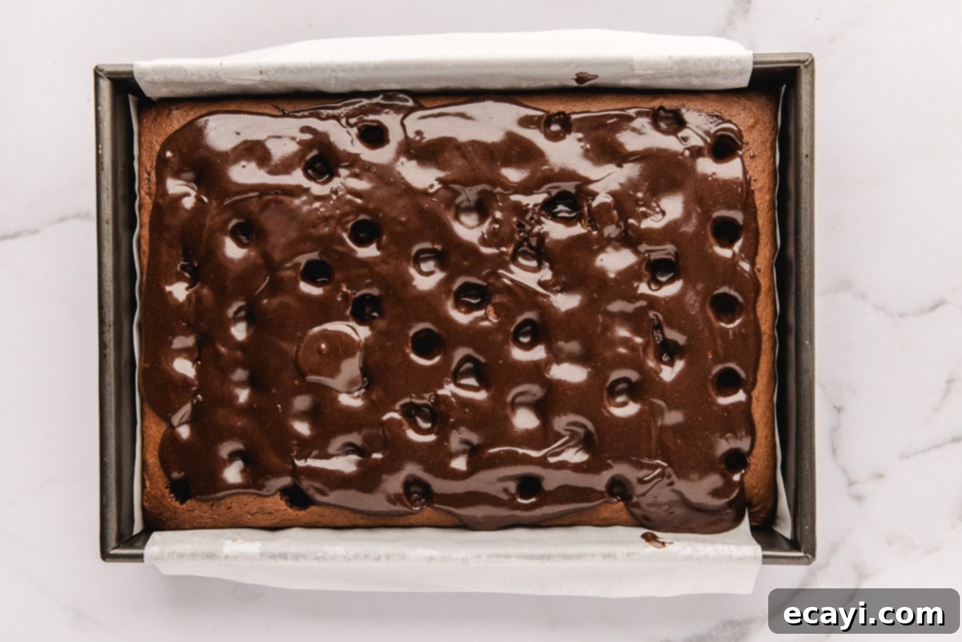 Decadent Black Forest Poke Cake 8 fudge sauce poured over holes in chocolate cake