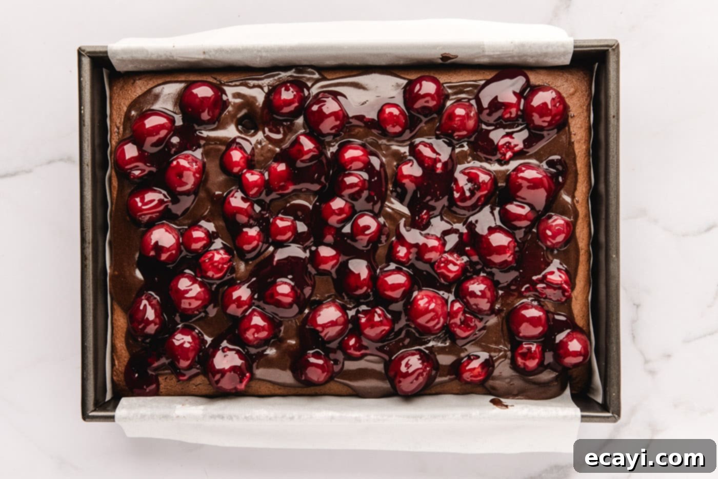 Decadent Black Forest Poke Cake 9 cherry pie filling added on top of fudge sauce and chocolate cake