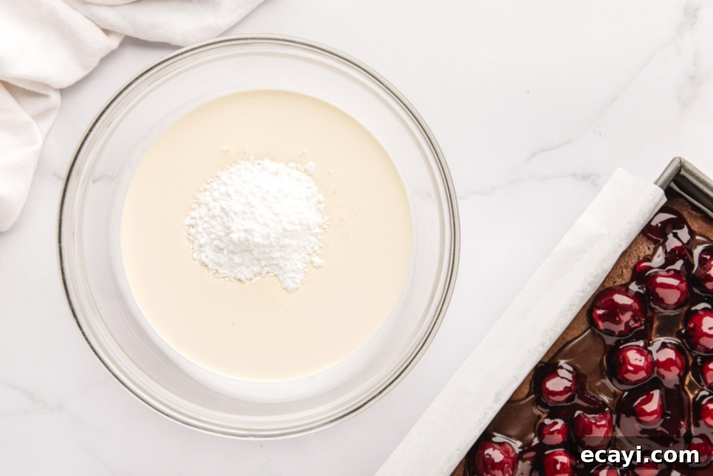 Decadent Black Forest Poke Cake 10 powdered sugar and heavy whipping cream in a bowl