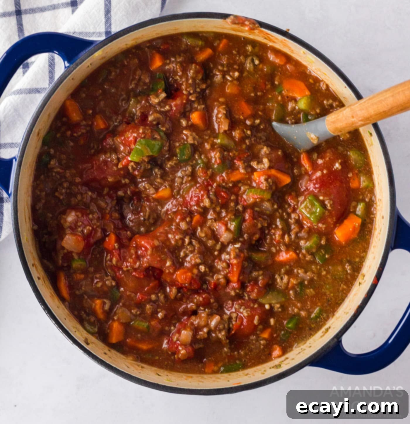 Hearty Bolognese Ragù 8 A large pot of Bolognese sauce gently simmering uncovered on the stovetop, showing rich texture and depth of color.