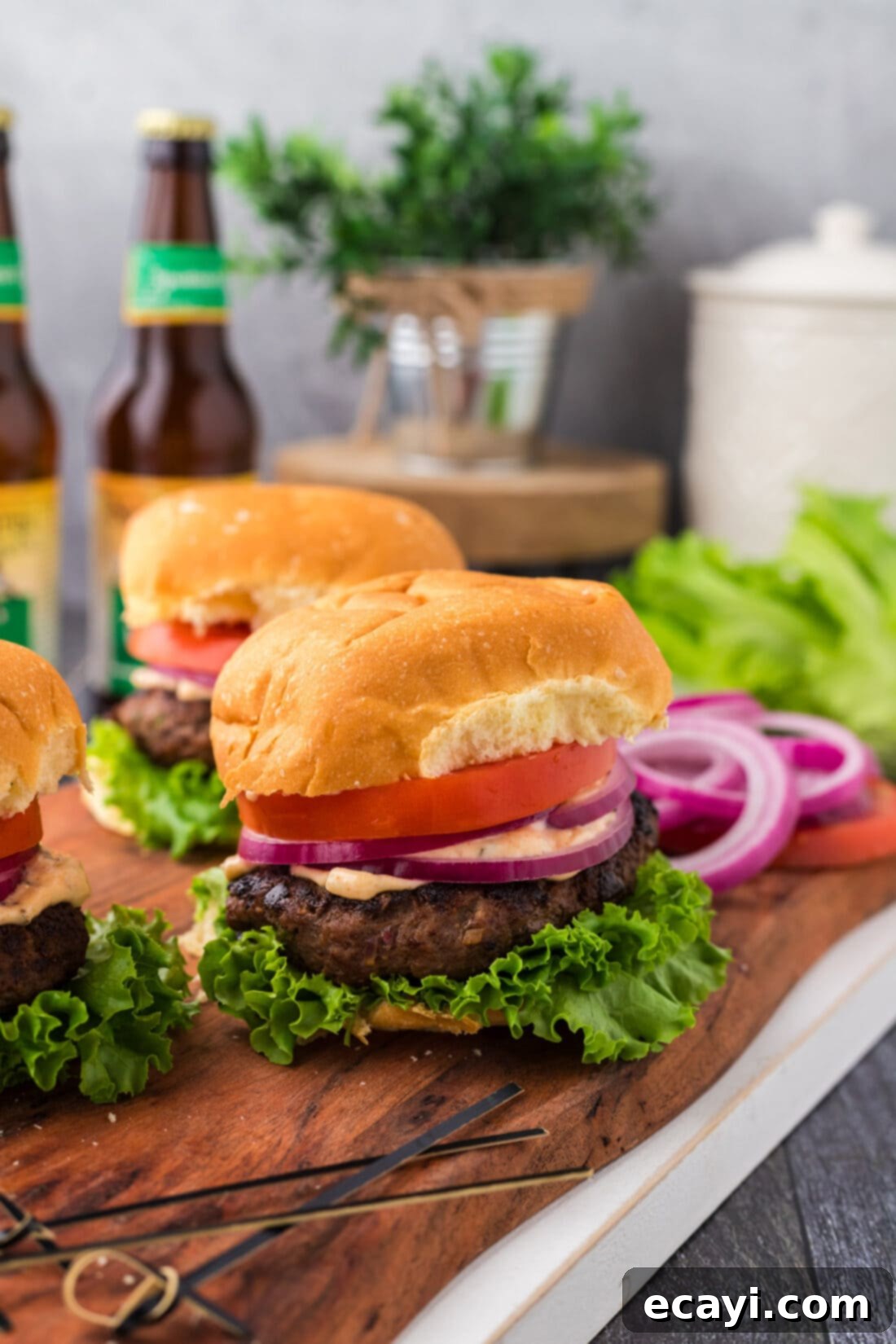 Premium Bison Burger 2 Buffalo Burger on a wooden board with more burgers behind it