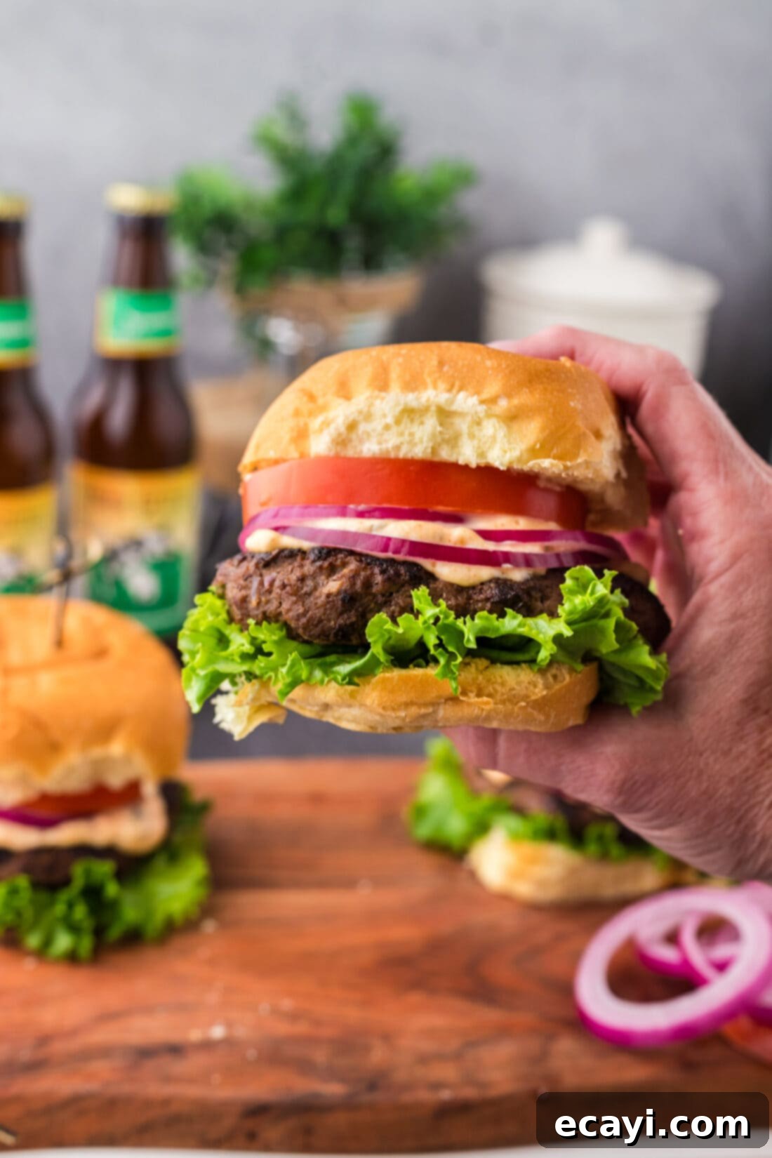 Premium Bison Burger 12 Hand holding up a Buffalo Burger