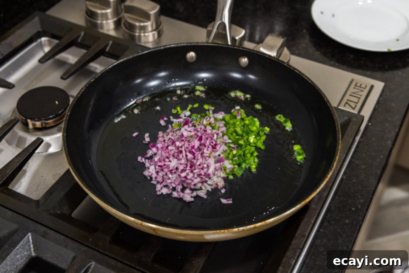 Premium Bison Burger 5 chopped onion and jalapeno peppers in a skillet with oil