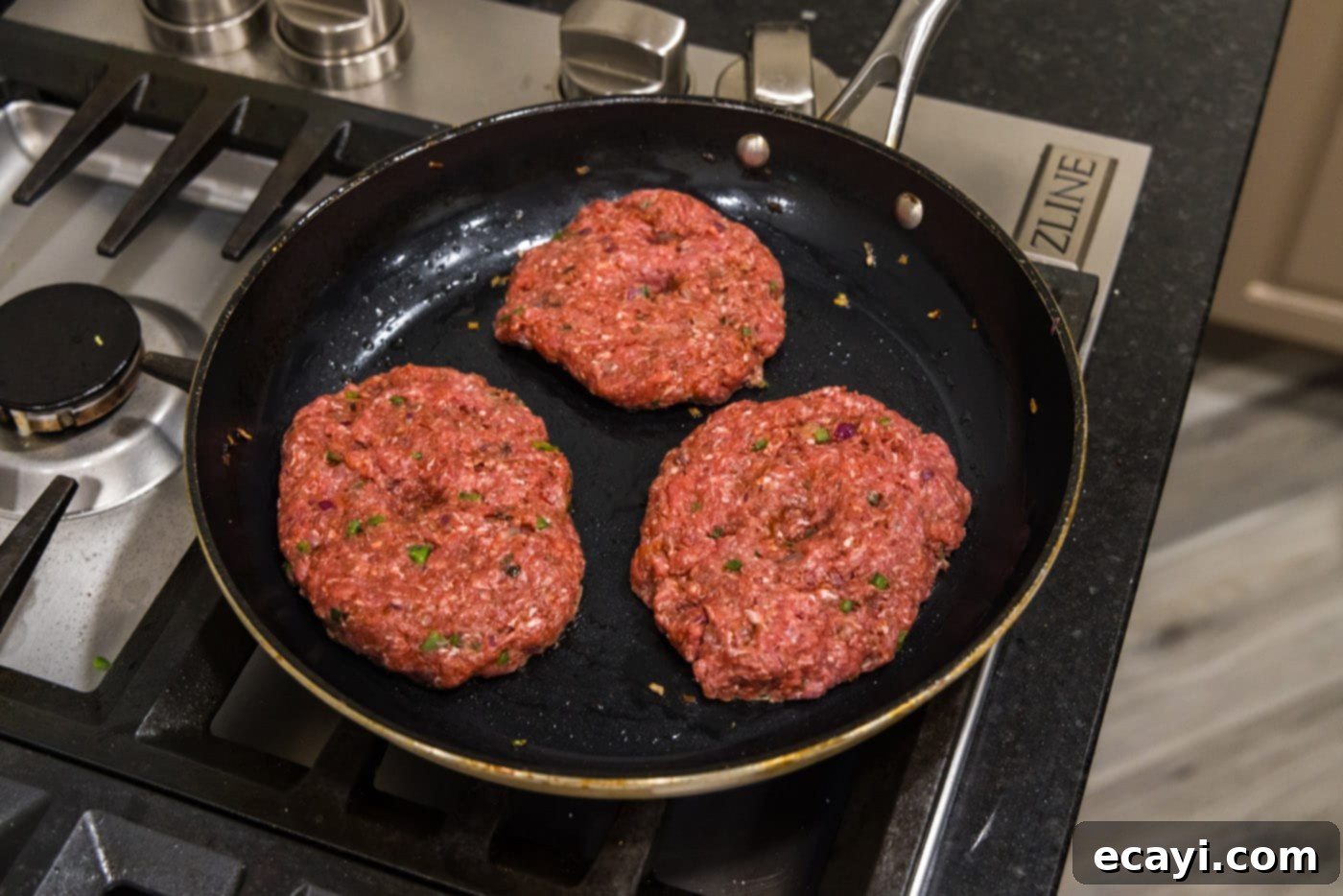 Premium Bison Burger 10 cooking bison burgers in a skillet