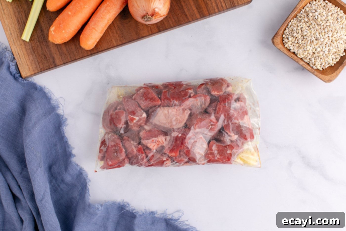 Wholesome Beef and Barley Comfort 5 Beef stew meat coated in flour and salt in a Ziploc bag, ready for searing.