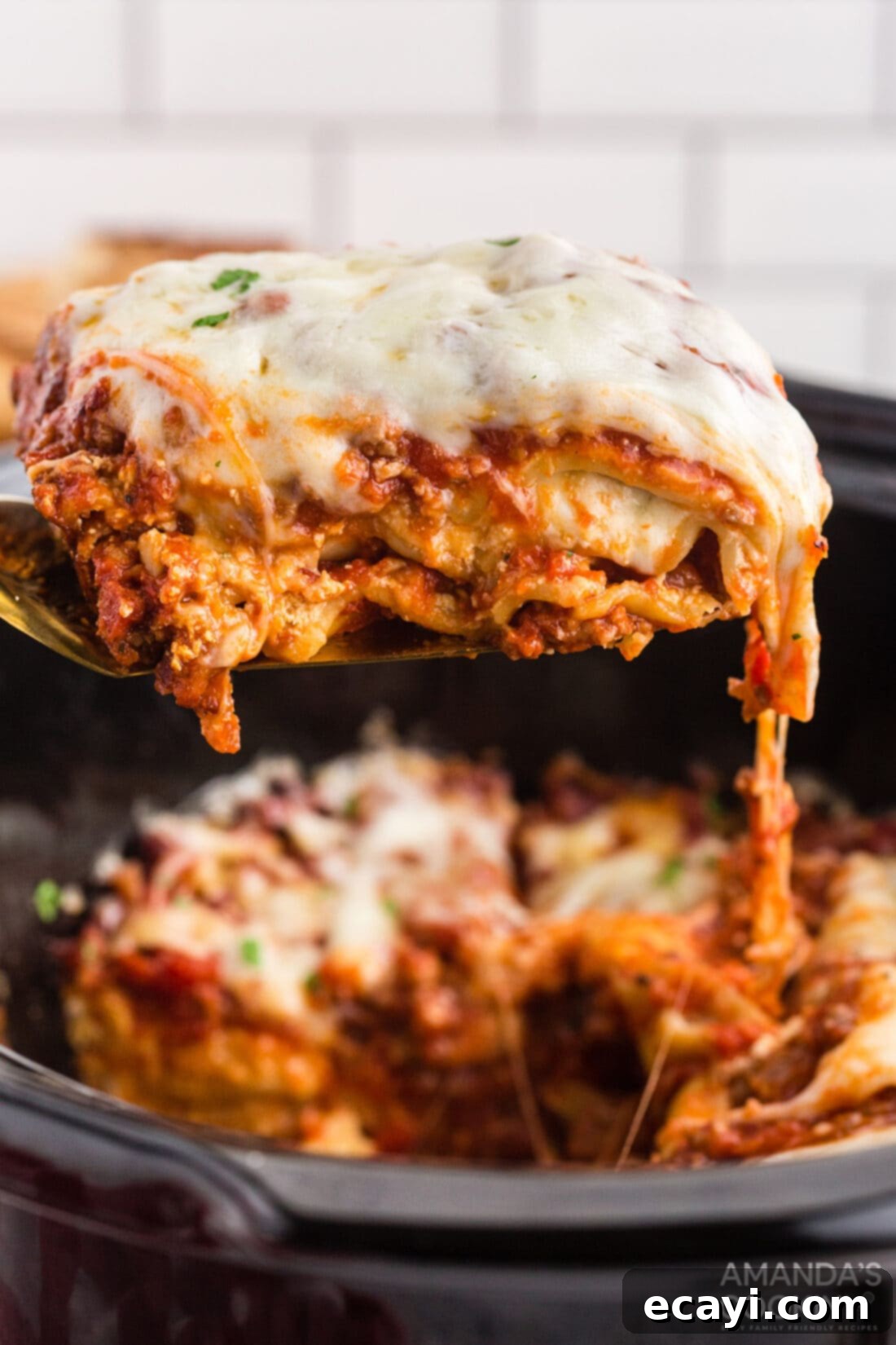 Unlocking Your Slow Cooker 5 A spatula gently lifting a generous slice of perfectly cooked lasagna from a crockpot, showcasing the layers of pasta, cheese, and sauce.
