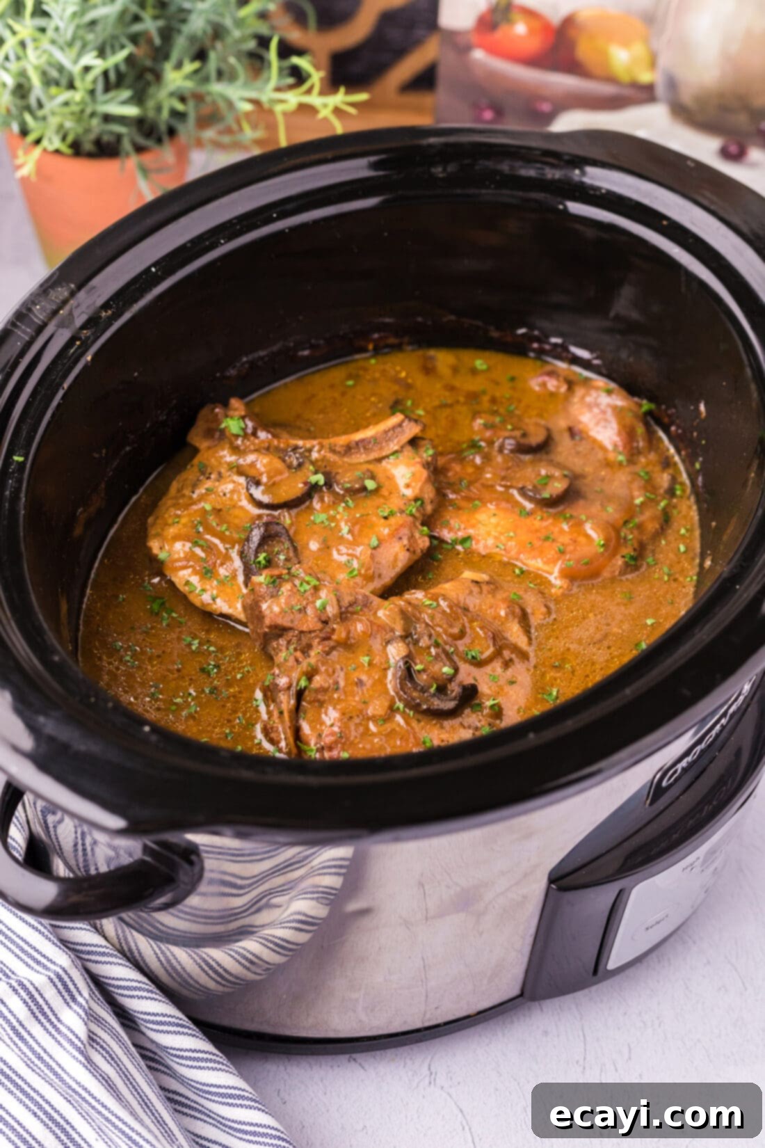 Unlocking Your Slow Cooker 7 Tender Crockpot Pork Chops, bathed in a savory sauce, cooked to perfection in a slow cooker, ready to be served as an effortless family dinner.
