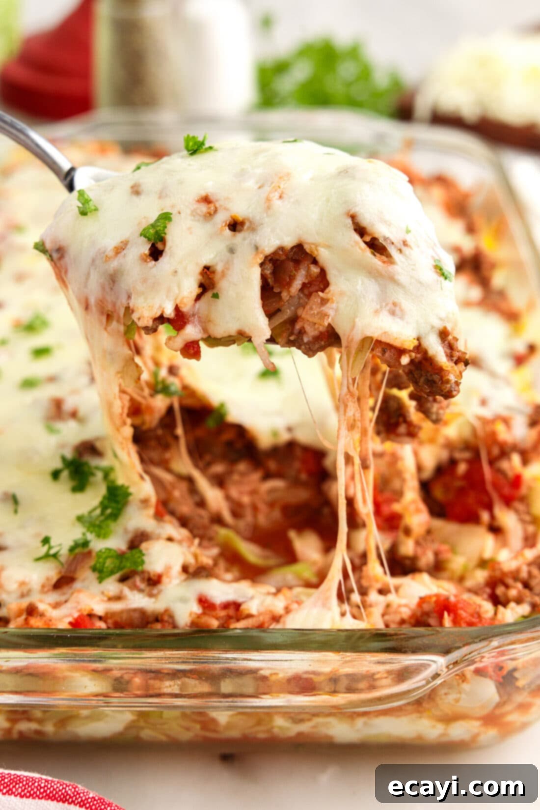 Hearty Cabbage Roll Bake 2 Scoop of Cabbage Roll Casserole being lifted out of the dish, showcasing the layers of meat, rice, and cabbage