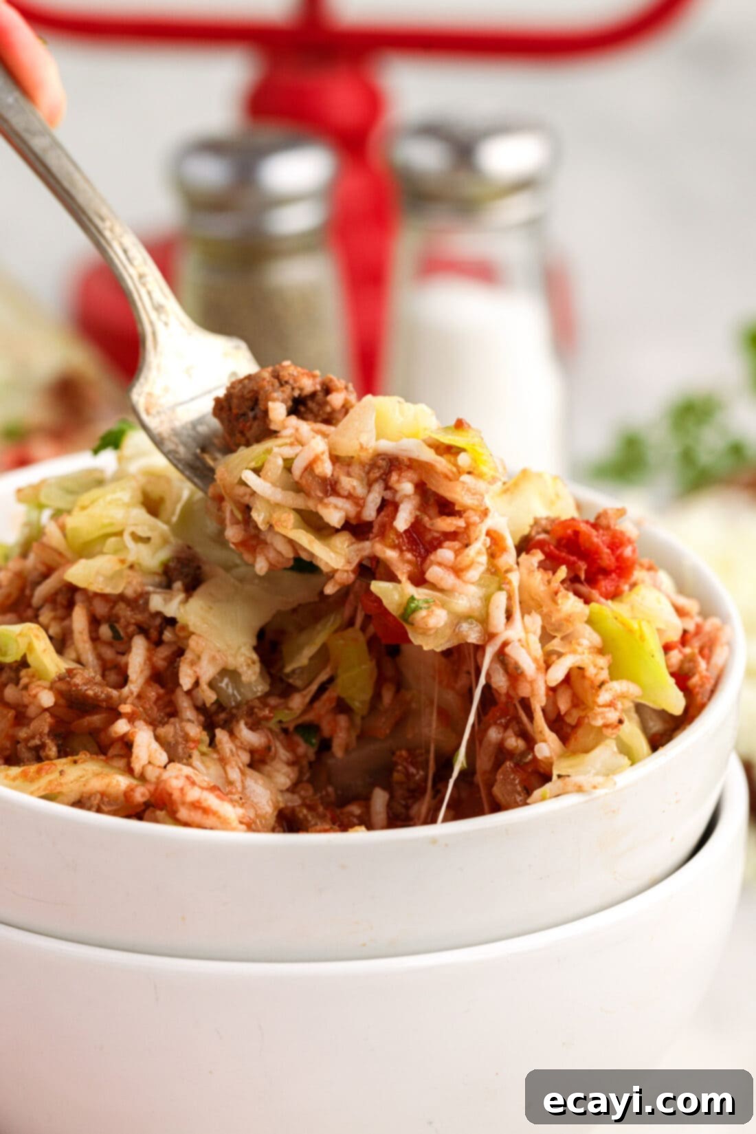 Hearty Cabbage Roll Bake 15 Forkful of Cabbage Roll Casserole being lifted out of a bowl, showing the rich texture