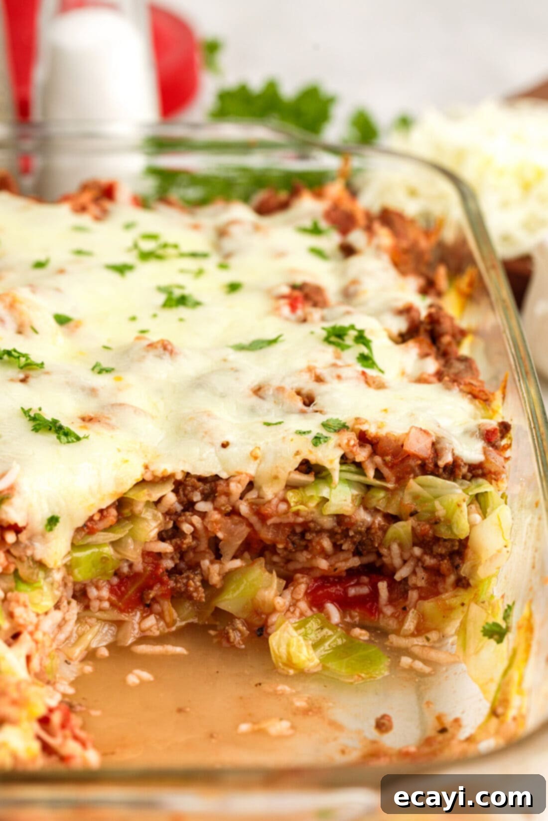Hearty Cabbage Roll Bake 3 Large pan of Cabbage Roll Casserole with a serving removed, ready to enjoy