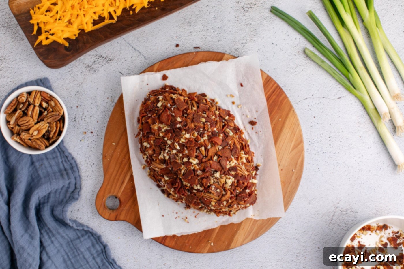 Touchdown Cheese Ball 14 chopped bacon and pecans on top of cheese ball