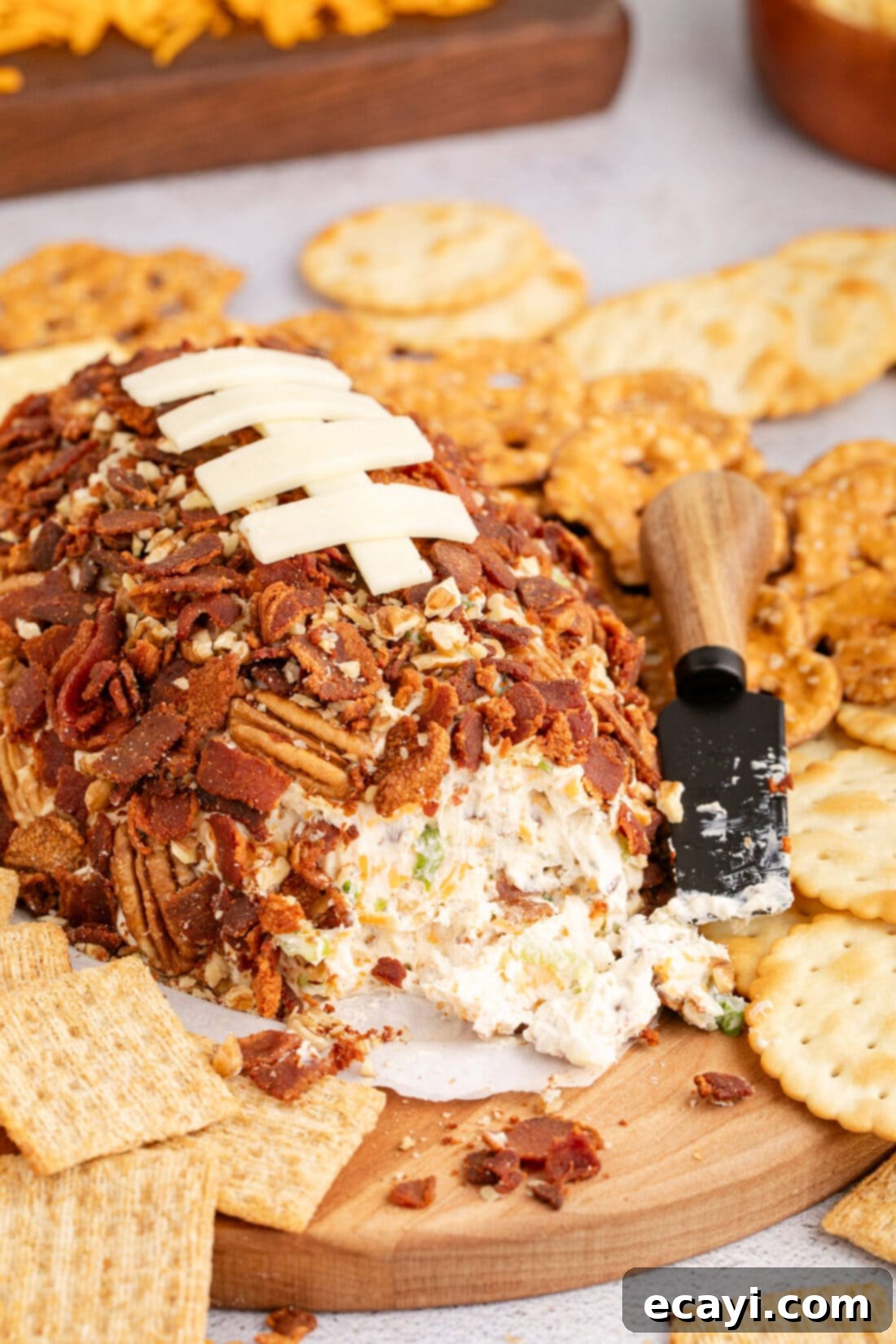 Touchdown Cheese Ball 3 Football Cheese Ball on a platter with some removed