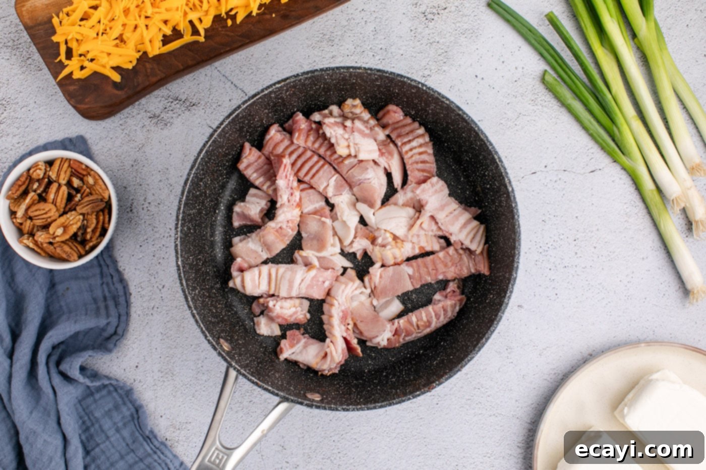 Touchdown Cheese Ball 5 bacon strips in a skillet