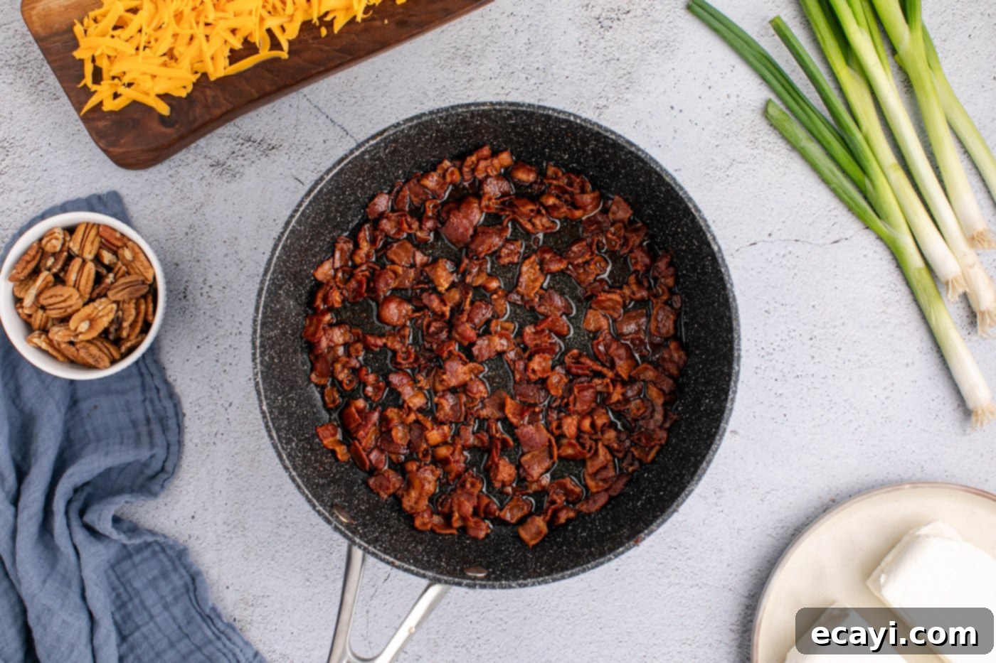 Touchdown Cheese Ball 6 cooked bacon bits in a skillet