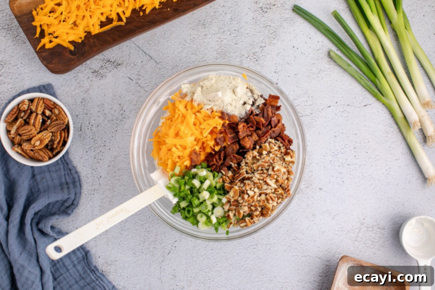 Touchdown Cheese Ball 10 cheddar cheese, pecans, bacon, green onions, and cream cheese mixture in a bowl
