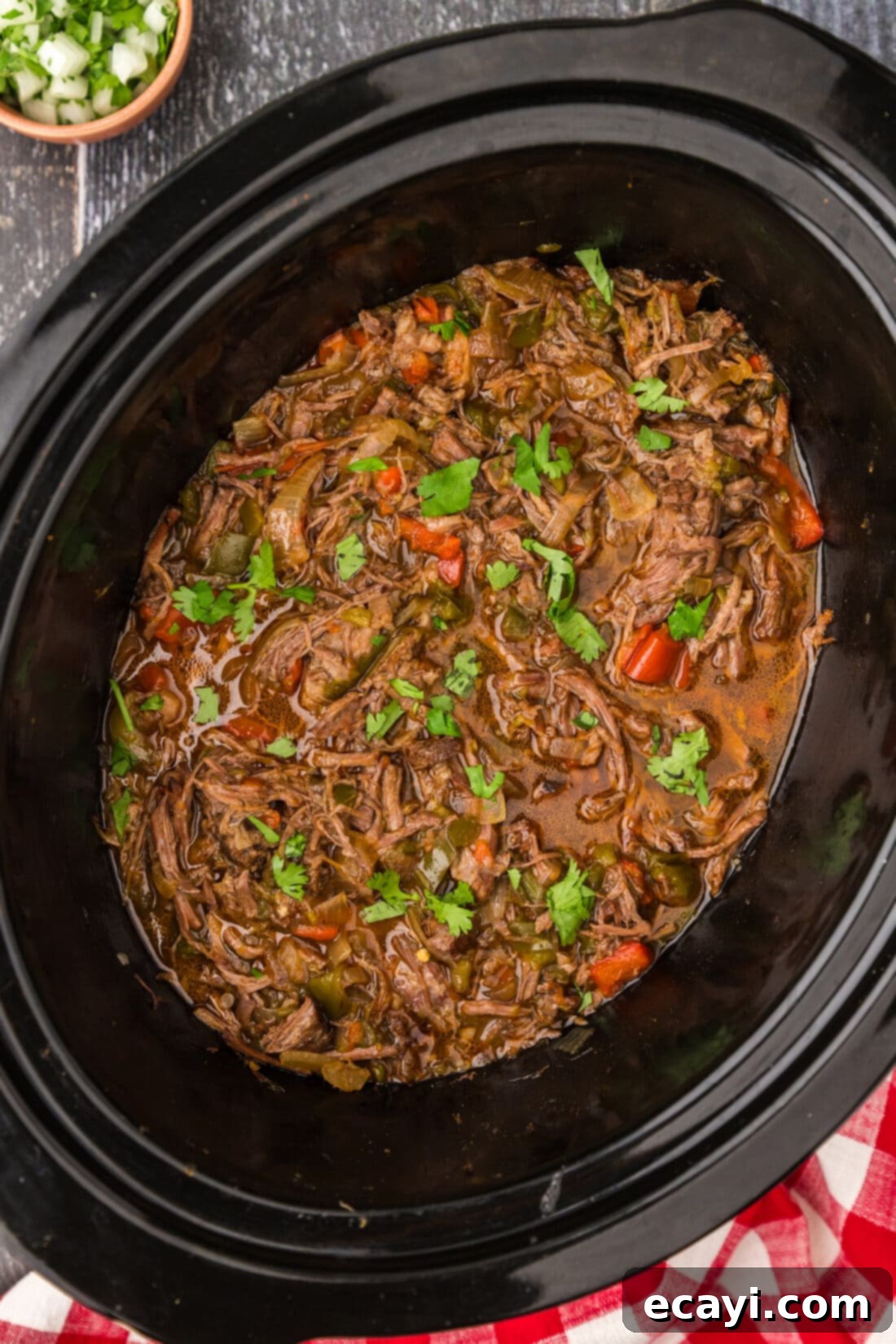 Golden Crispy Beef Carnitas 3 Beef Carnitas simmering in a crockpot with bell peppers, onion, and green chiles