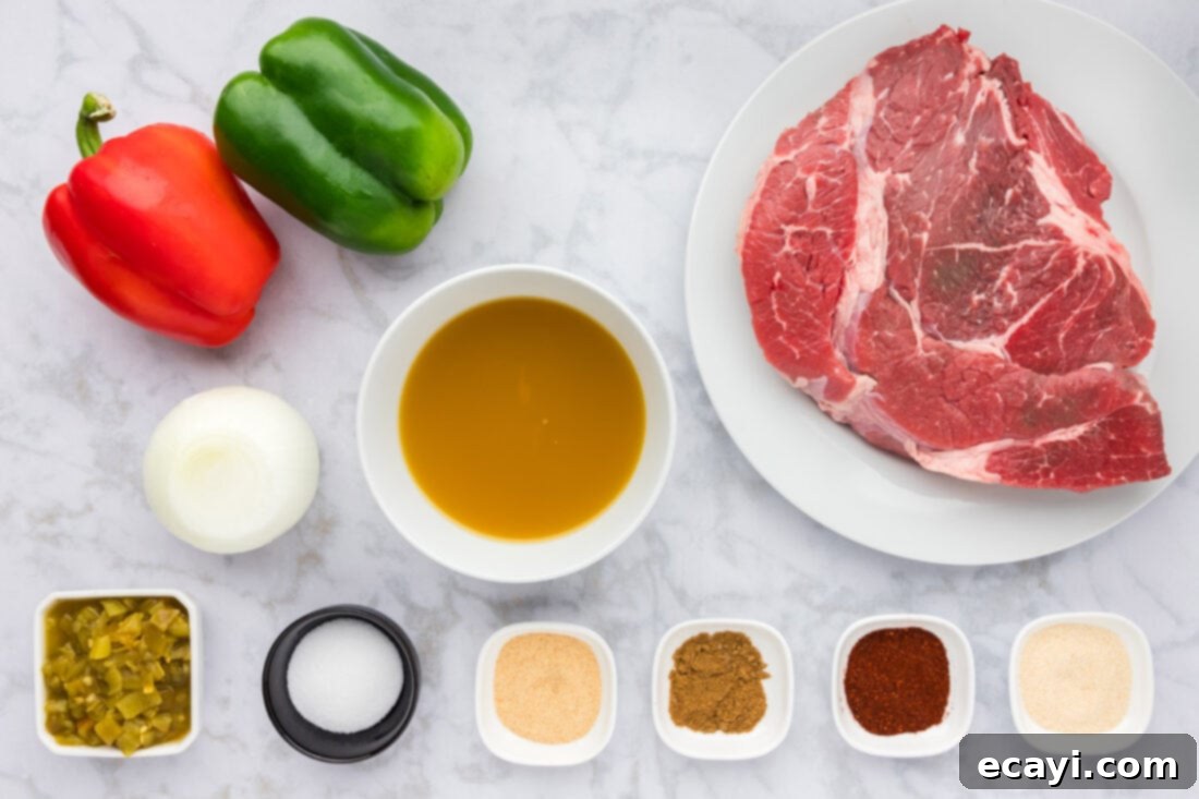 Golden Crispy Beef Carnitas 4 Fresh ingredients for Slow Cooker Beef Carnitas laid out on a cutting board, including chuck roast, bell peppers, onion, green chiles, and spices
