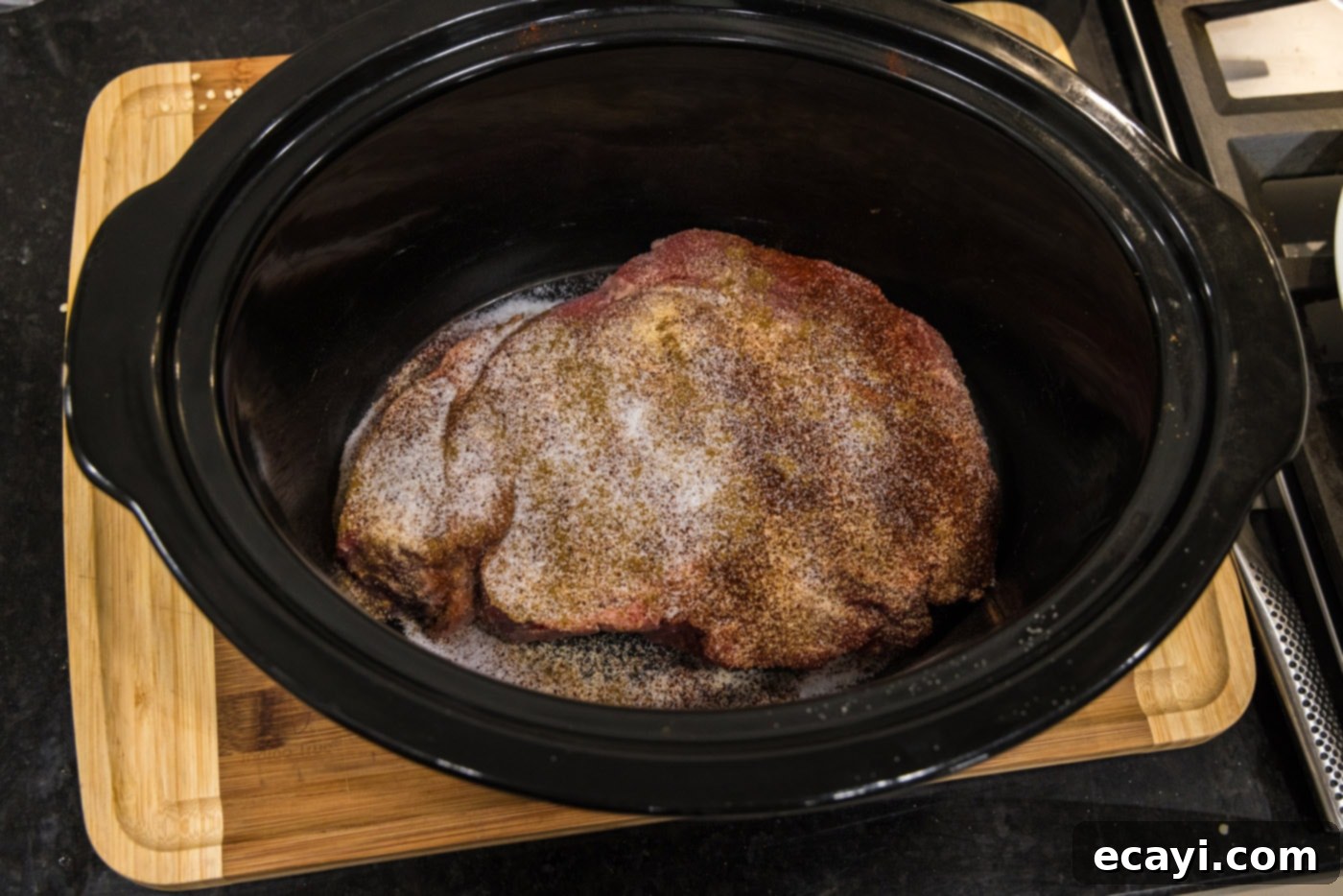 Golden Crispy Beef Carnitas 5 seasoned chuck roast in slow cooker crock, coated evenly with a blend of spices