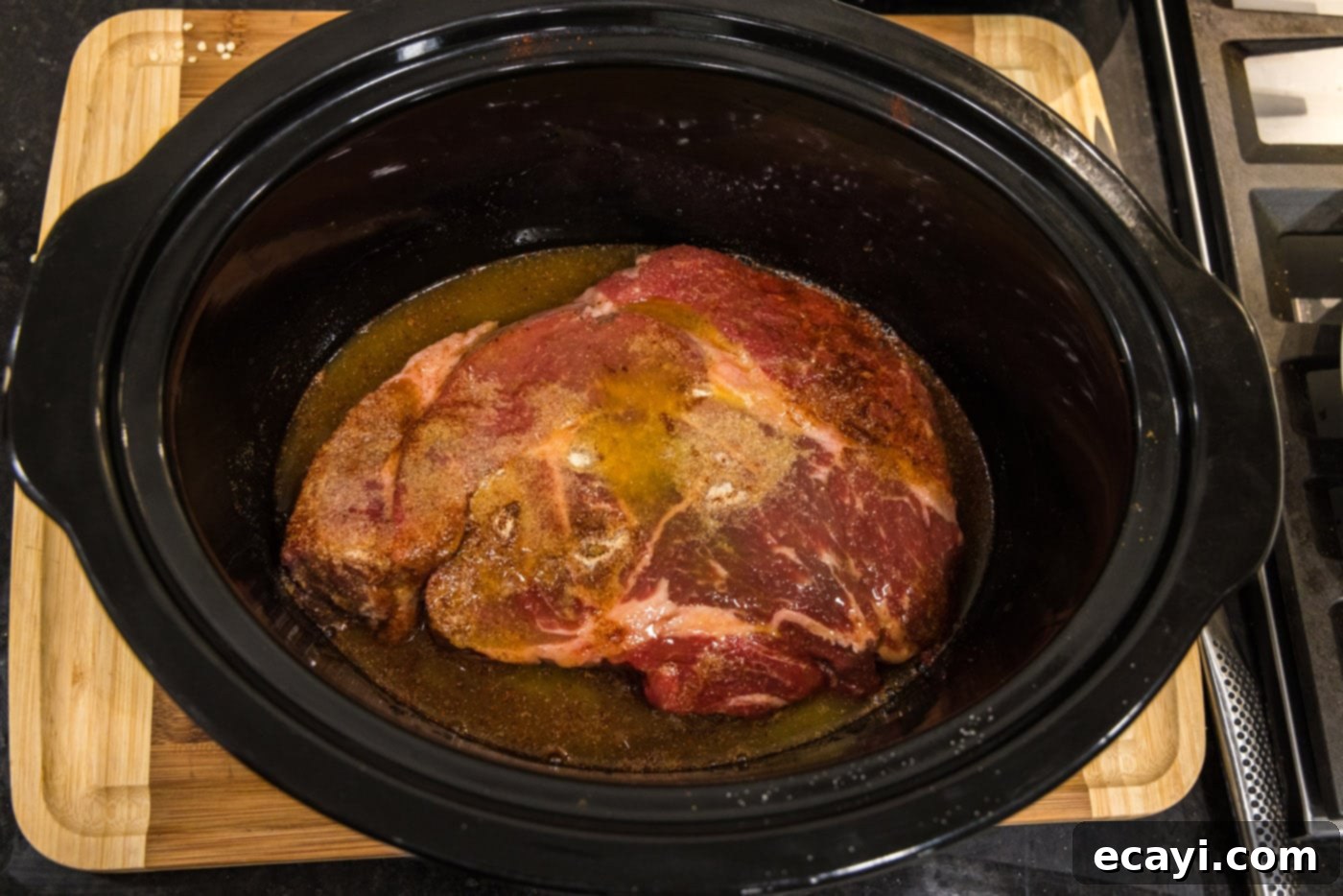 Golden Crispy Beef Carnitas 7 crockpot beef carnitas with chuck roast ready for cooking, submerged in flavorful liquid