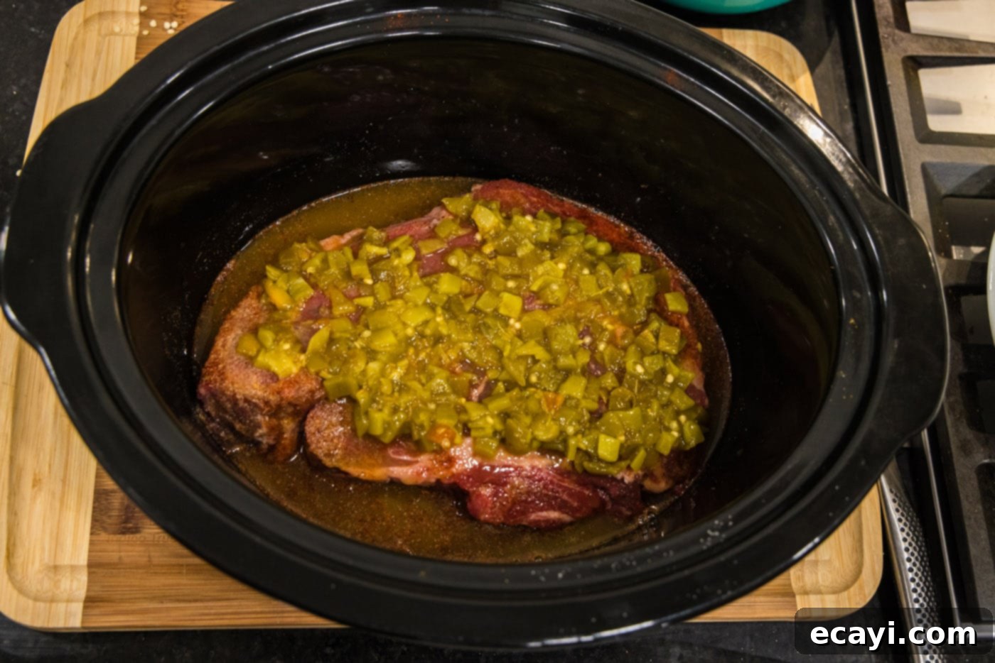 Golden Crispy Beef Carnitas 8 green chiles on top of chuck roast in crockpot, adding a mild, earthy heat