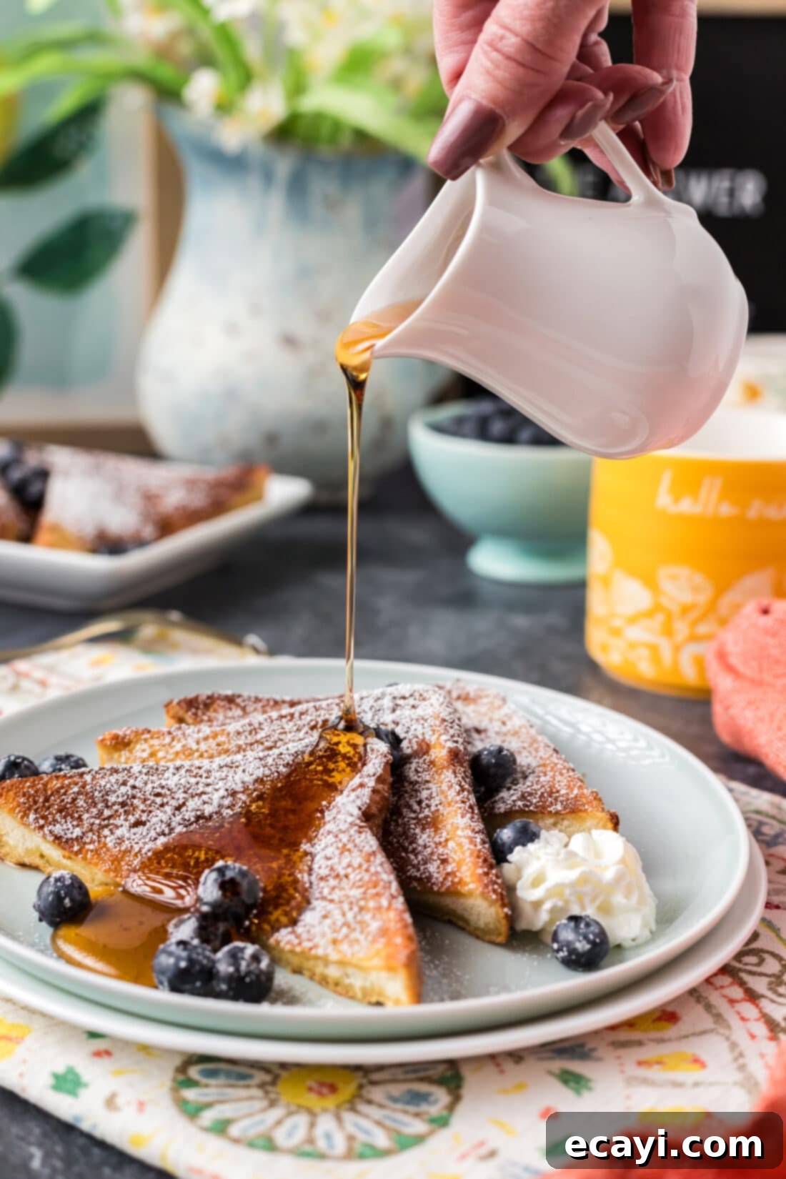 Perfect Air Fryer French Toast 2 Syrup being drizzled over three slices of golden Air Fryer French Toast on a plate, ready to be enjoyed.