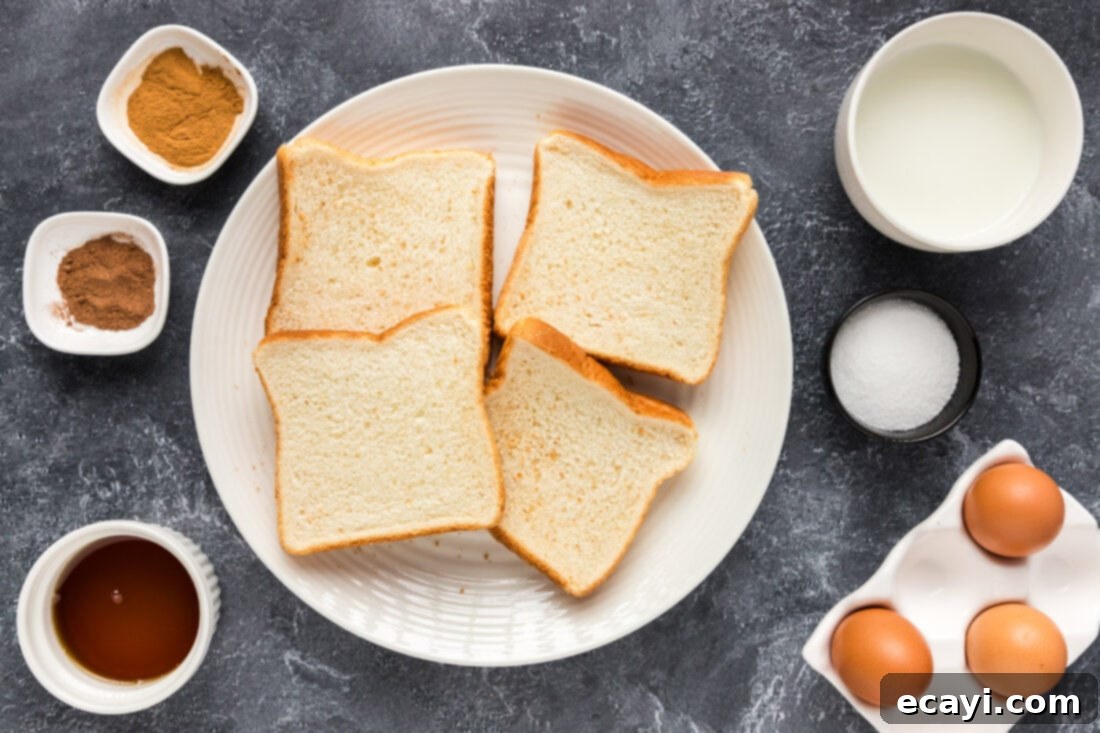 Perfect Air Fryer French Toast 4 A selection of fresh ingredients including Texas toast, eggs, milk, cinnamon, nutmeg, and maple syrup, laid out for Air Fryer French Toast preparation.