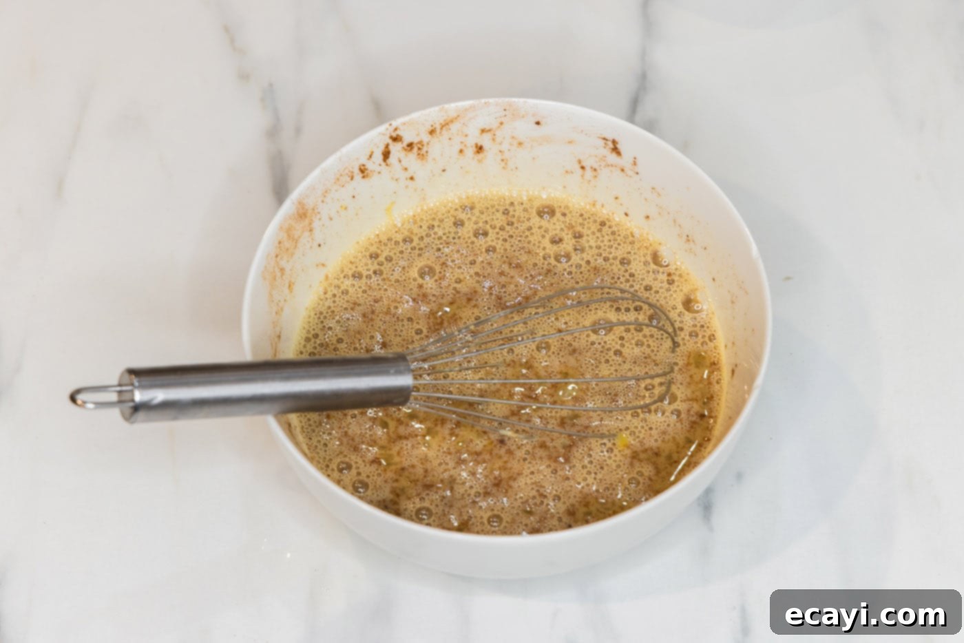 Perfect Air Fryer French Toast 6 A bowl of perfectly whisked French toast bread batter, smooth and ready for dipping.