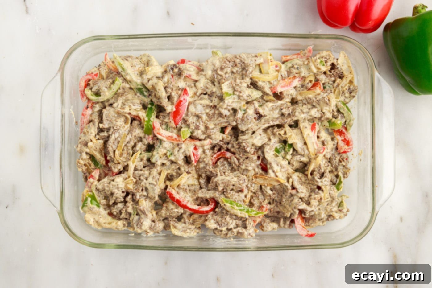 Hearty Philly Cheesesteak Casserole 14 philly cheesesteak casserole ingredients spread in a baking dish