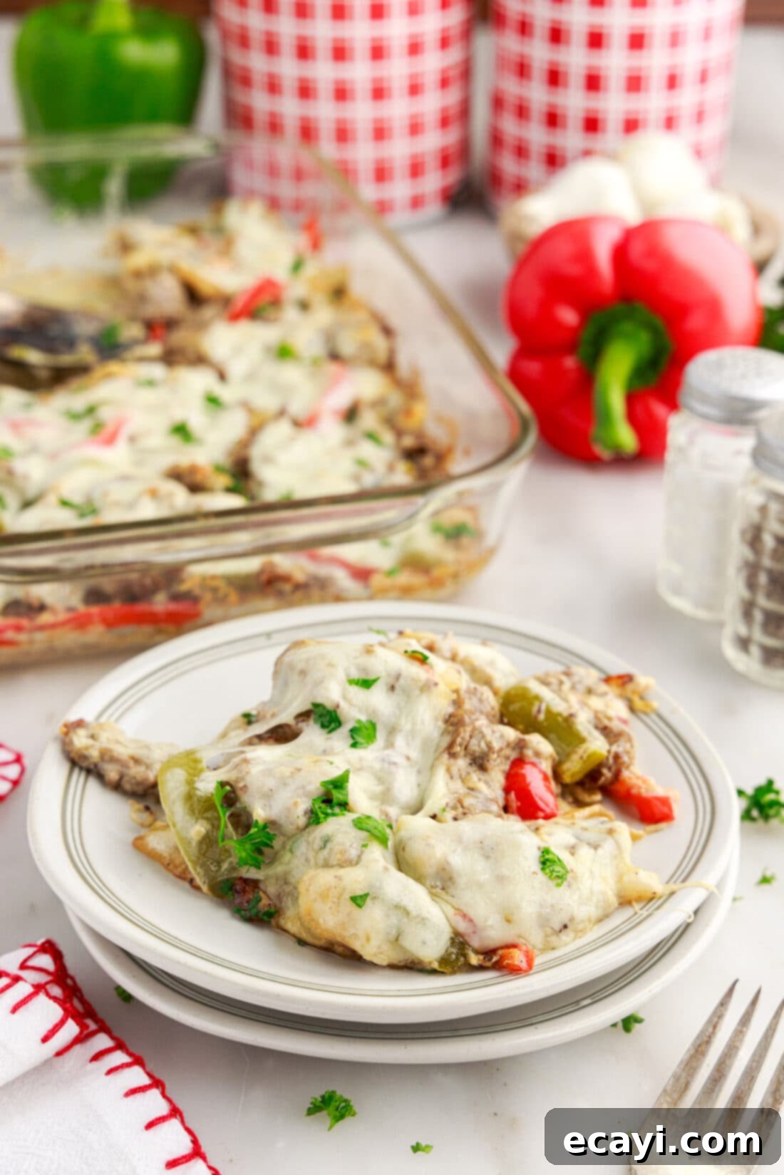 Hearty Philly Cheesesteak Casserole 17 Philly Cheesesteak Casserole on a plate with a fork, showing its delicious texture
