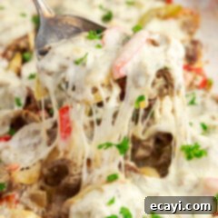 Hearty Philly Cheesesteak Casserole 18 Spoonful of Philly Cheesesteak Casserole being lifted out of the pan