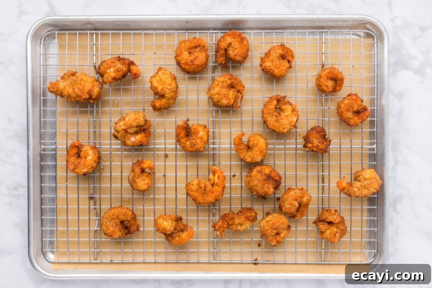 Crispy Fried Shrimp 13 golden fried breaded shrimp on a baking sheet